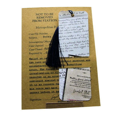 Black tassel bookmark on a vintage-style document with text