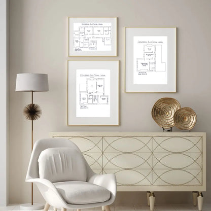 Modern interior with a white armchair, decorative lamp, and patterned wall art.