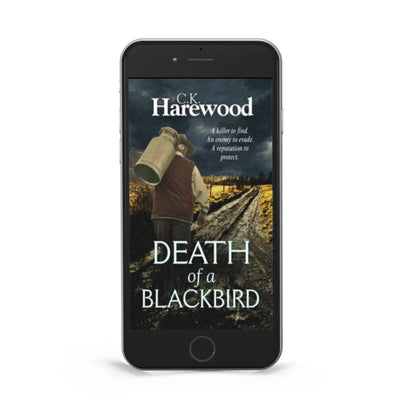 Phone displaying the book cover of 'Death of a Blackbird' by C.K. Harewood on a white background
