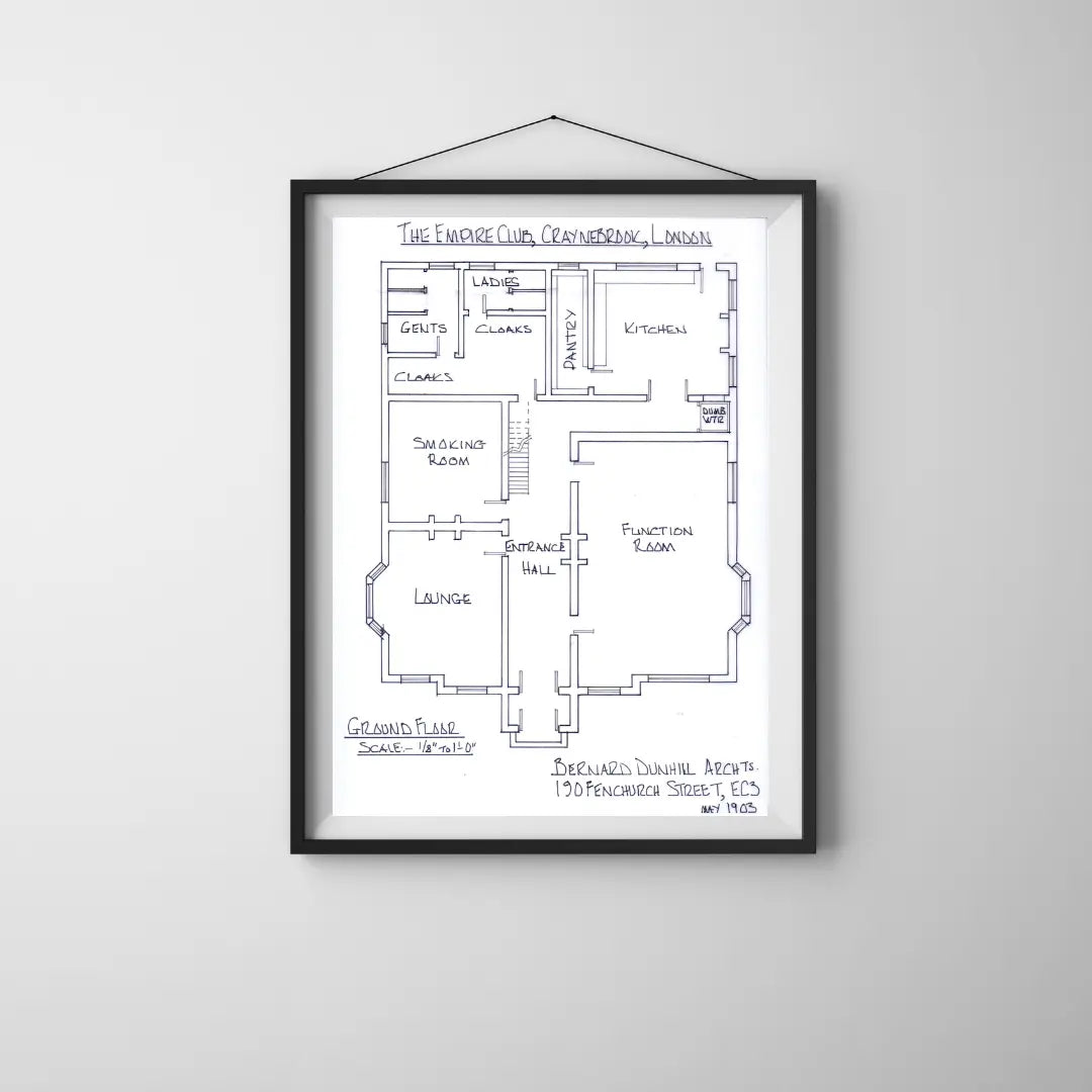 Framed floor plan of a building on a white wall