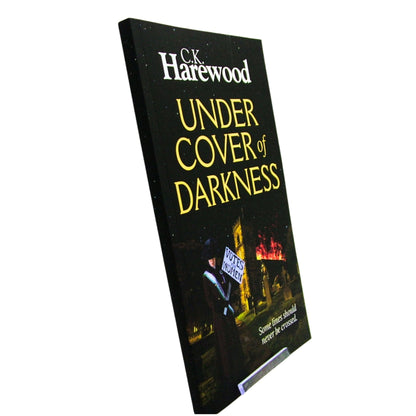 Book titled 'Under Cover of Darkness' by C.K. Harewood on a white background
