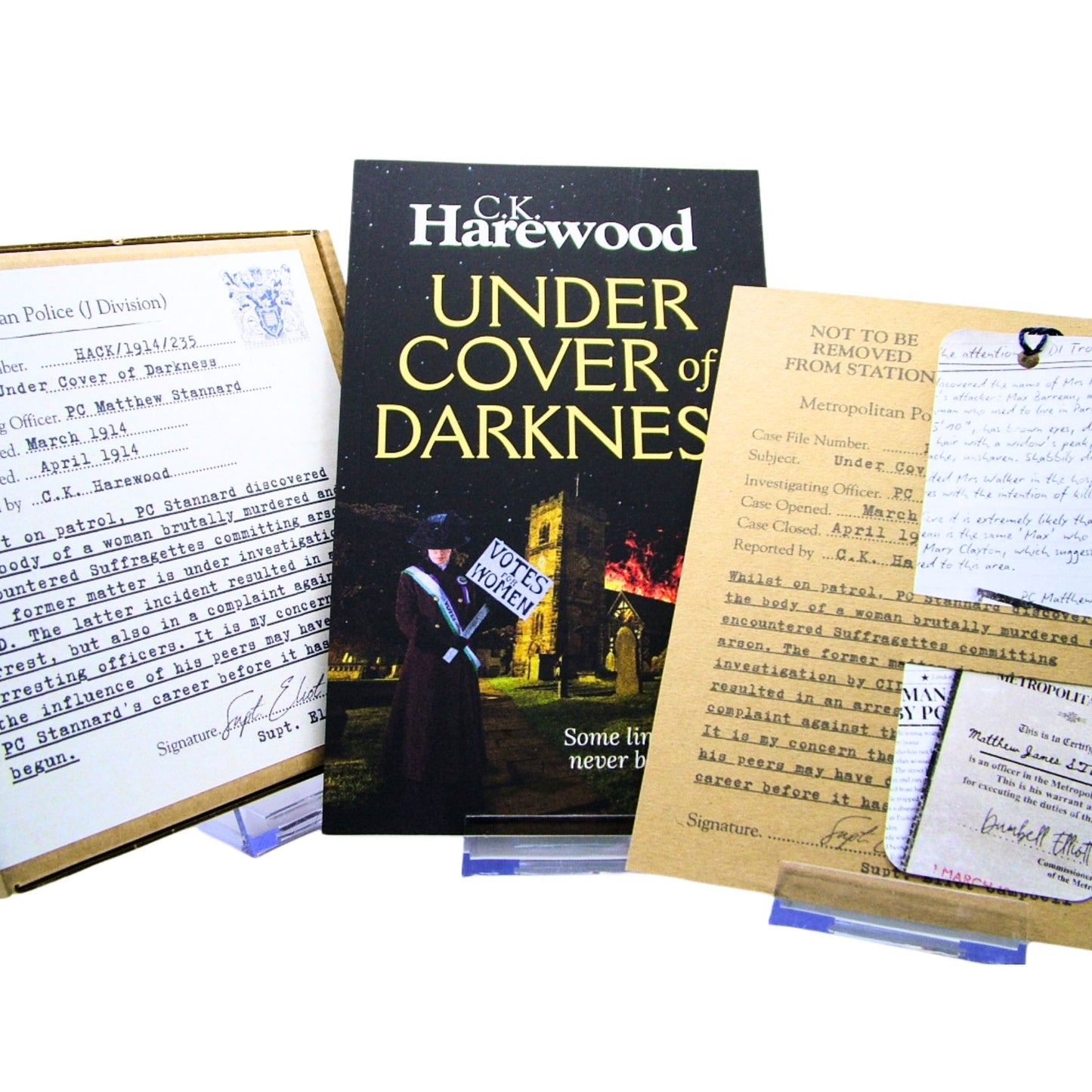 Book titled 'Under Cover of Darkness' by C.K. Harewood with Audio CD Boxset and Bookmark in Case File Presentation