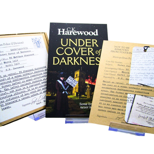 Book titled 'Under Cover of Darkness' by C.K. Harewood with Audio CD Boxset and Bookmark in Case File Presentation
