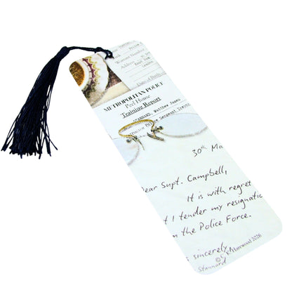 Bookmark with tassel featuring a letter and illustrations on a white background