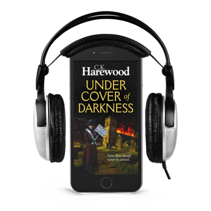 Phone displaying 'Under Cover of Darkness' by C.K. Harewood with headphones on a white background